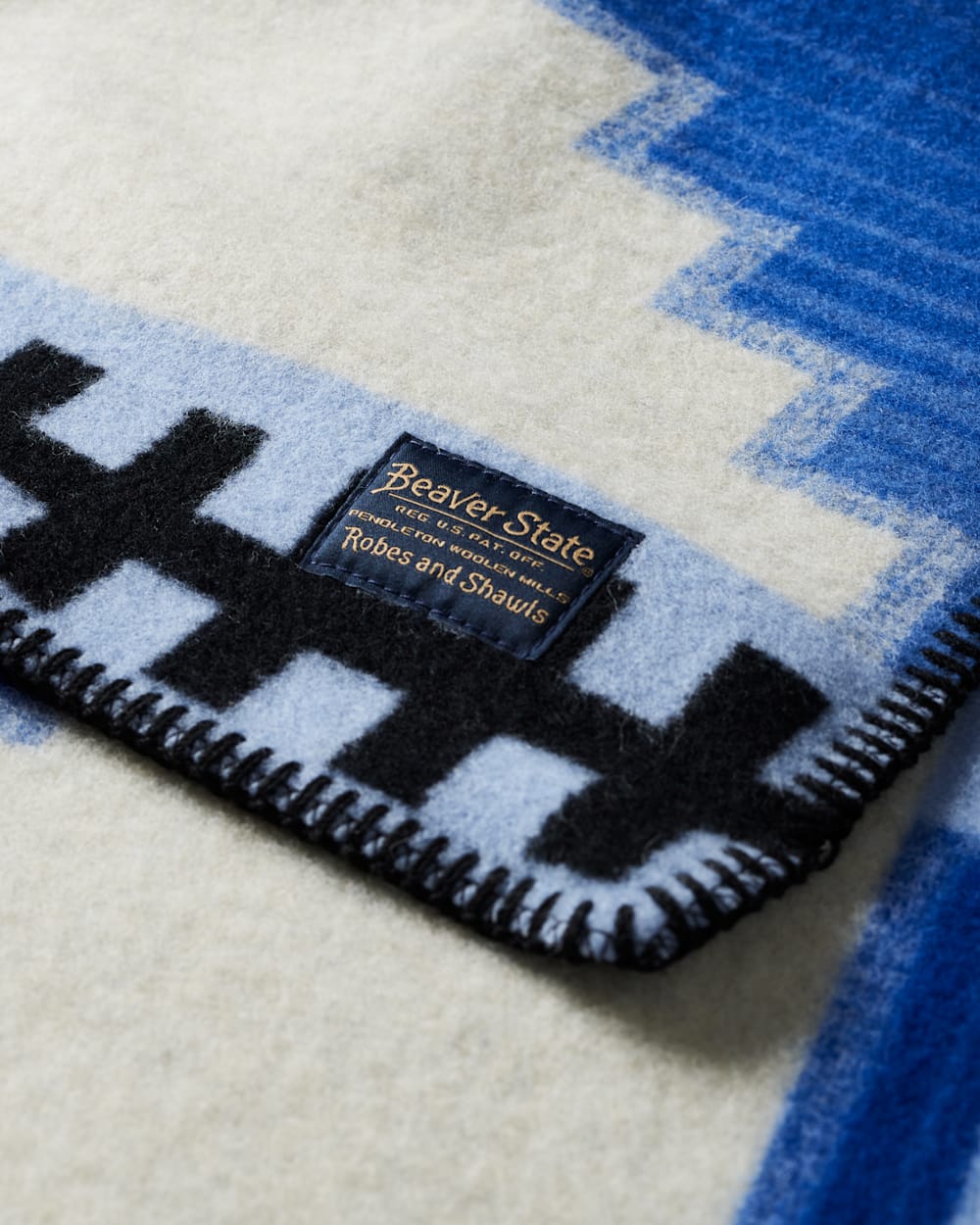CLOSE UP VIEW OF LABEL ON MORNING SKY CRIB BLANKET IN BLUE/WHITE image number 5