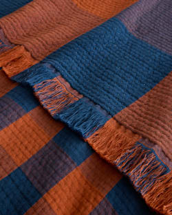 ALTERNATE VIEW OF BLOCK PLAID ORGANIC COTTON FRINGED THROW IN COPPER/INDIGO image number 4