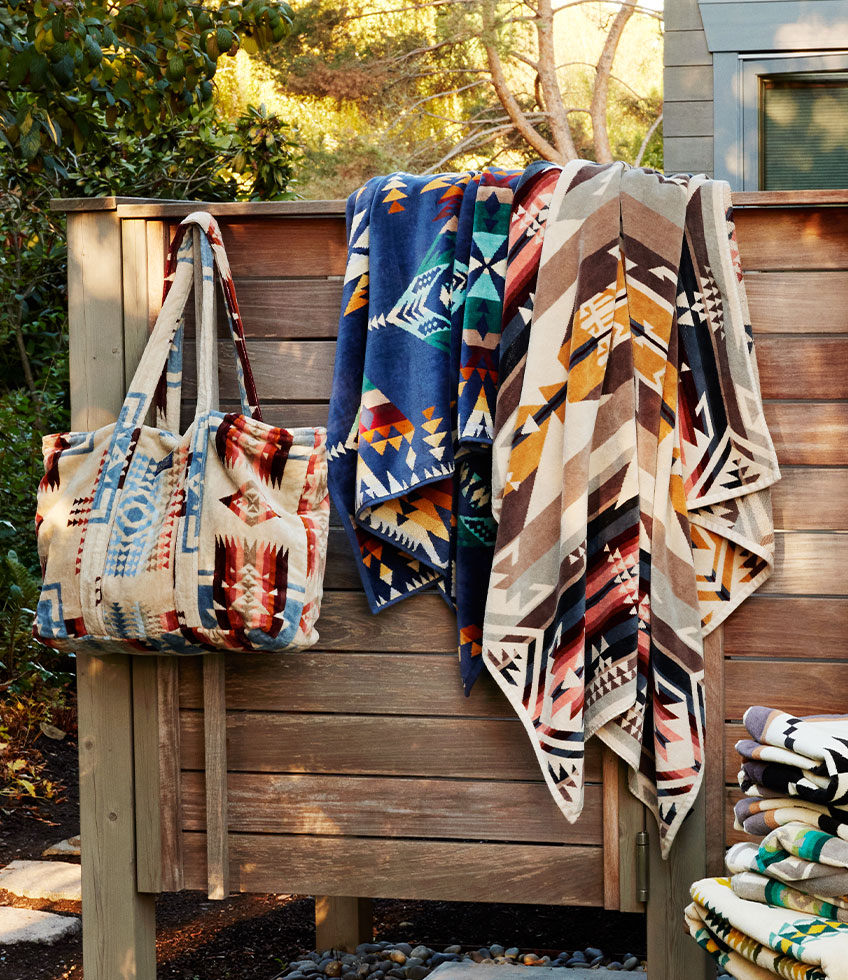 Beach towels hanging on a fence